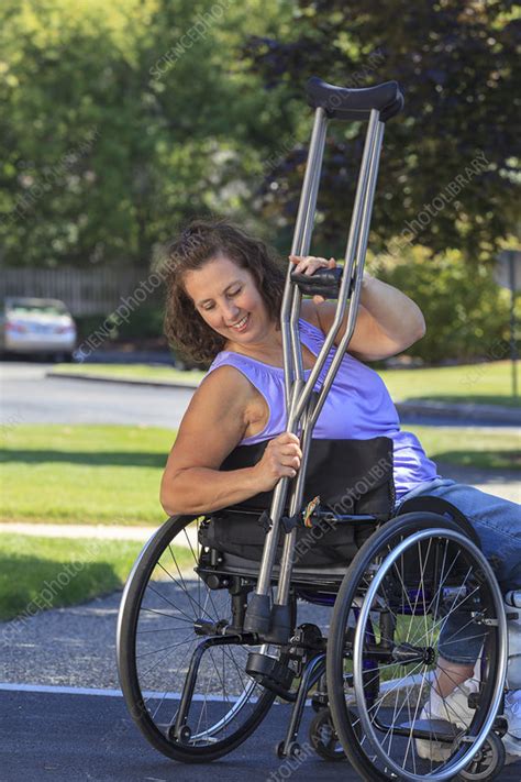 Woman Attaching Crutches To Wheelchair Stock Image F0124412