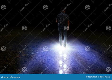 Man Walking With Light Foot Prints In Darkness Stock Photo Image Of