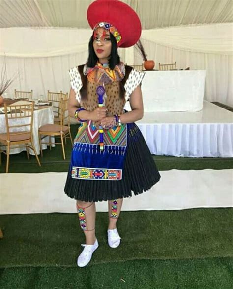 Zulu Bride In Traditional Imvunulo Wedding Attire With Red Isicholo Hat