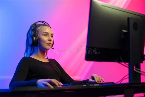 Happy Gamer Girl With Headset Playing Online Video Game On Pc Stock