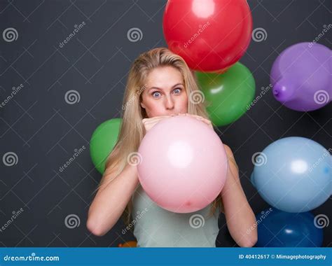 blond woman inflating balloons for a party stock image image of closeup cute 40412617