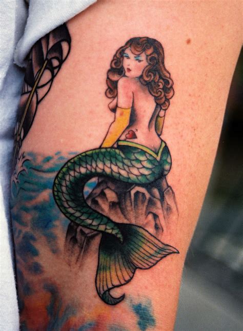 This design has a traditional aesthetic and as such has very strong contrasts in colors. Traditional Ship And Mermaid Tattoos » Tattoo Ideas