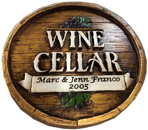 A Wine Cellar Sign On Top Of A Wooden Barrel