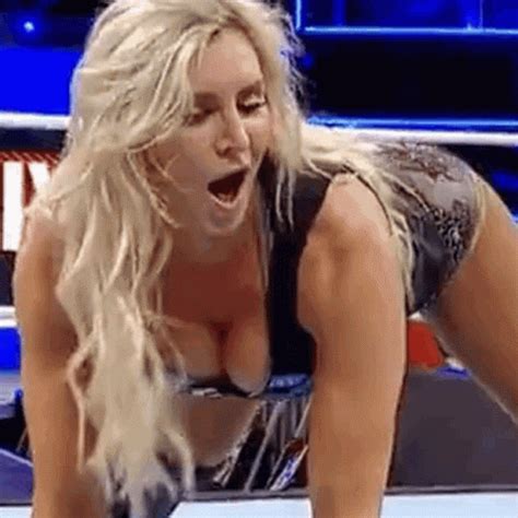 A Woman In A Wrestling Ring With Her Hands On The Ground And Mouth Wide Open