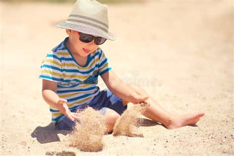 Holiday Little Boy Three Years Old Fun Digging In The Sand At The
