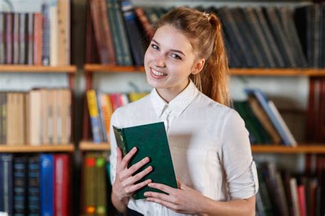 Portrait Of A Young Girl With A Book In The Library Stock Image