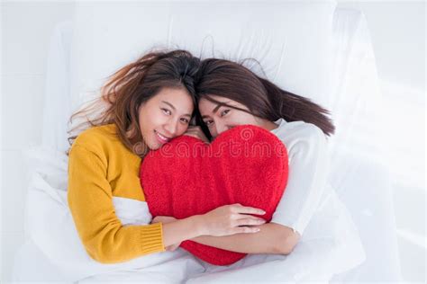 Asia Lesbian Lgbt Couple Lay On Bed And Hug Rainbow Color Pillow Heart Shape With Happiness