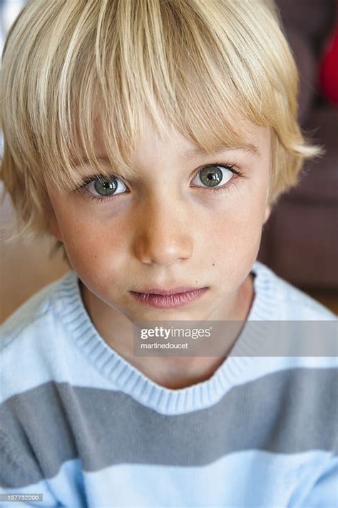 Portrait Of A Cute And Serious Young Boy High Res Stock