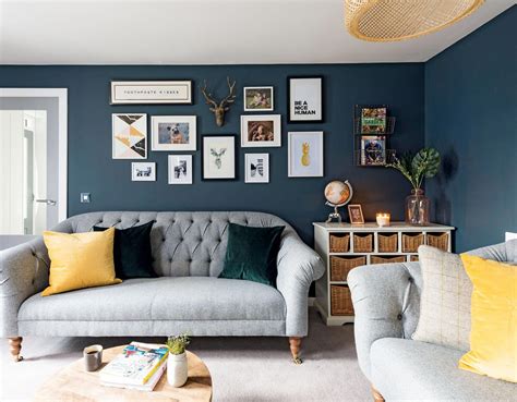 You can consider your gray sofa a solid investment piece that will remain. A dark navy living room with yellow accents and a grey sofa #RusticDecorEvent | Living room grey ...