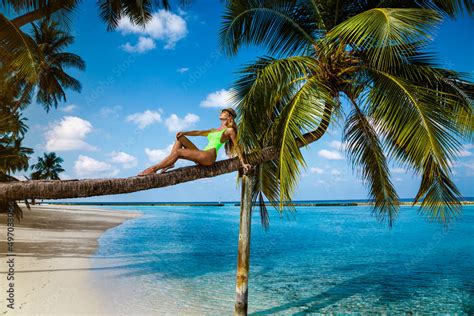 Beautiful Woman In A Bikini On A Palm Tree On The Paradise Beach Of Maldives Sexy Model Posing