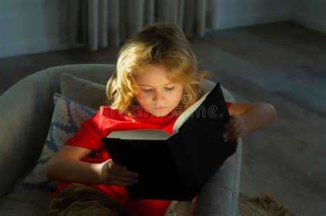 Portrait Of Cute Blonde Child Reading Interesting Kids Book Story