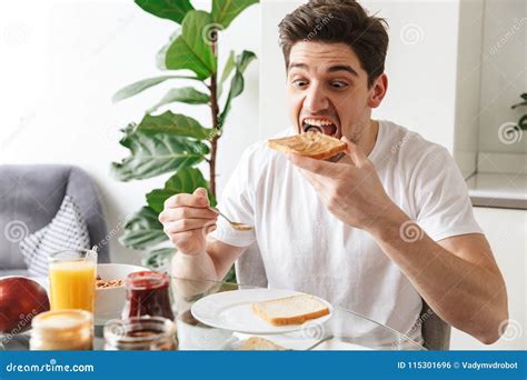 Portrait Of A Young Man Having Breakfast Stock Photo Image Of Food