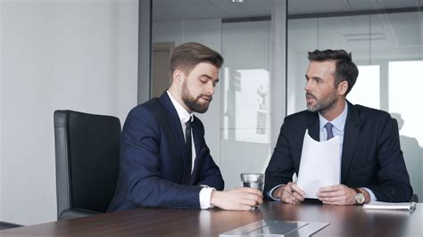 two businessmen talking during business meeting at corporate office stock footage business