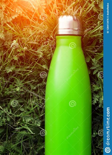 stainless thermos water bottle light green color mockup  green grass background