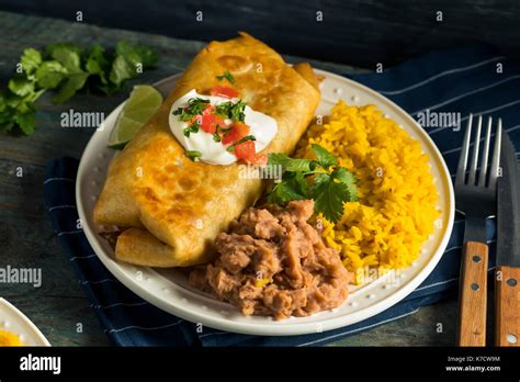 Deep Fried Beef Chimichanga Burrito With Rice And Beans Stock Photo Alamy