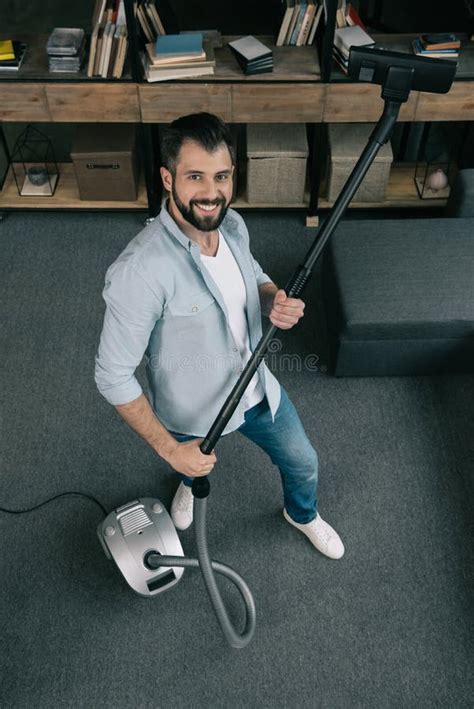 Caucasian Man Holding Vacuum Cleaner And Looking At Camera At Home Stock Image Image Of Smile