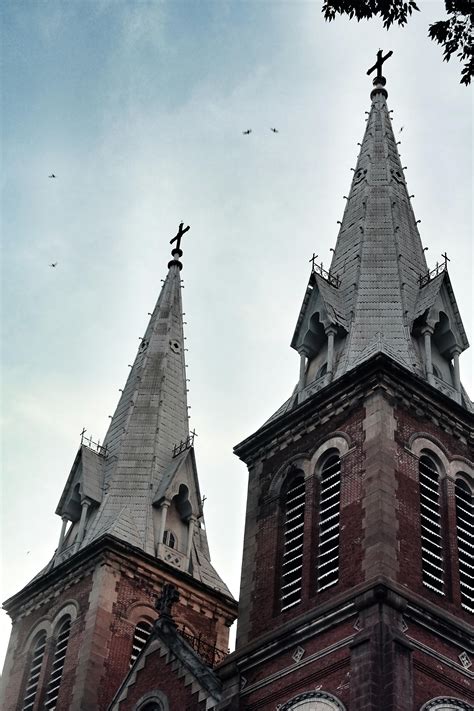 Pointed Roof Building Under Cloudy Skies · Free Stock Photo