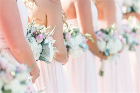 The Bridesmaids Are Holding Their Bouquets Together