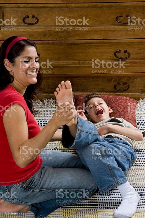 Familymother And Son Tickling Feet Stock Photo - Download Image Now ...