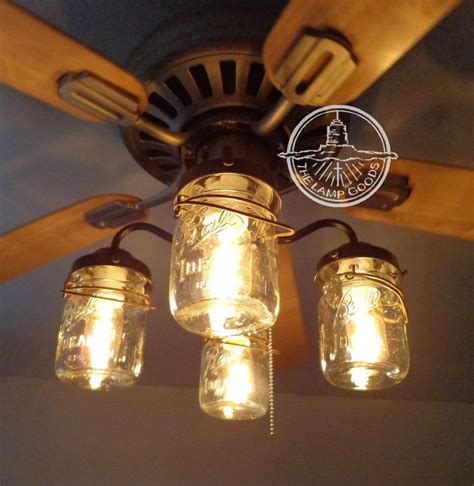 Three Mason Jar Lights Hanging From A Ceiling Fan