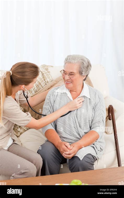 Nurse Taking The Heartbeat Of Her Patient Stock Photo Alamy
