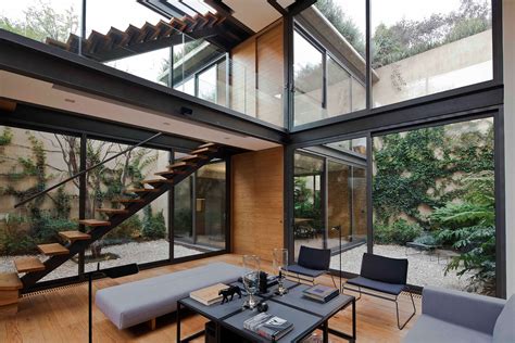 Airy Double Height Living Room Surrounded With Multiple Courtyards