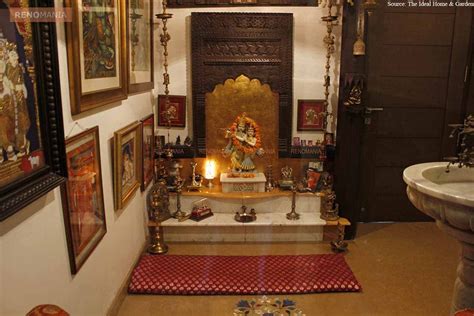 An Elegant Puja Room With Marble Floor And Hanging Bells And Idols