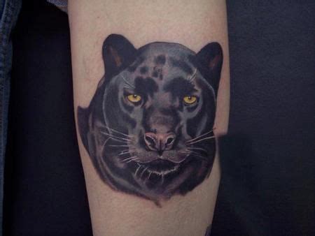 A Black Panther Tattoo On The Right Forearm And Leg With Yellow Eyes