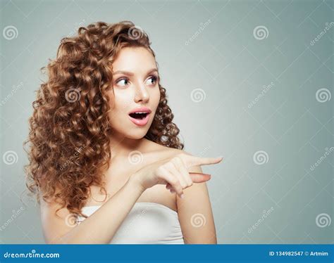 Woman Surprised Pointing Cute Female Model With Long Curly Hair Pointing To The Side