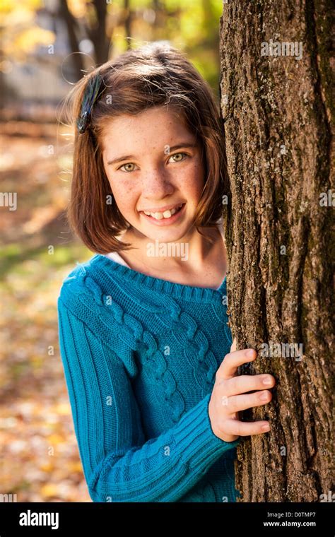 Young Girl Peeking Around Tree Usa Stock Photo Alamy
