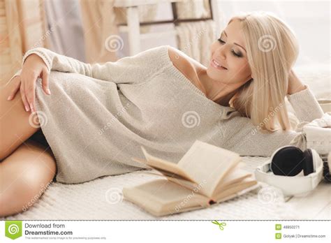 Woman Reading A Book Lying On The Sofa Stock Image Image Of Blonde