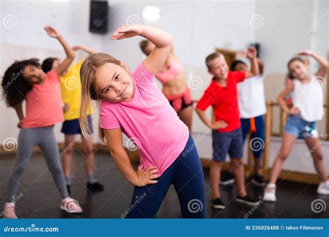 Girl Doing Stretching Exercises Before Dance Training Stock Photo