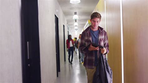 Young Student Group Walking Through The Hallway In Modern College