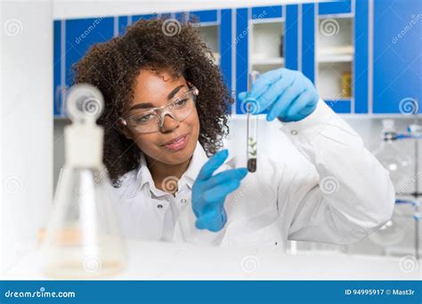 Female Laboratory Scientist Examining Plant Sample In Test Tube Work