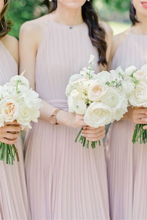 The Bridesmaids Are Holding Their Bouquets With White Flowers In Them And Wearing Pink Dresses