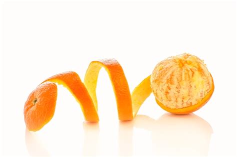 Premium Photo Oranges Peeled In Spiral Shape Isolated