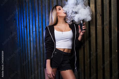 Portrait Of Sexy Young Vaping Girl Girl Blowing Vape Vapor Concept Vaping E Cigarette On Dark