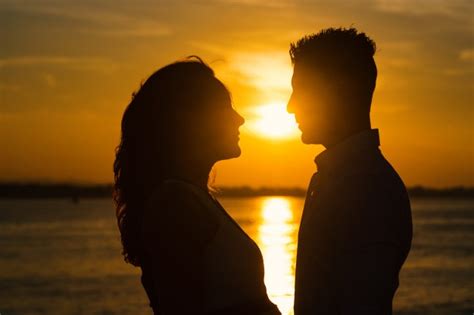 premium photo couple silhouettes on the beach at sunset