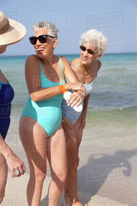 Senior Women Walking On Beach Stock Photo Dissolve