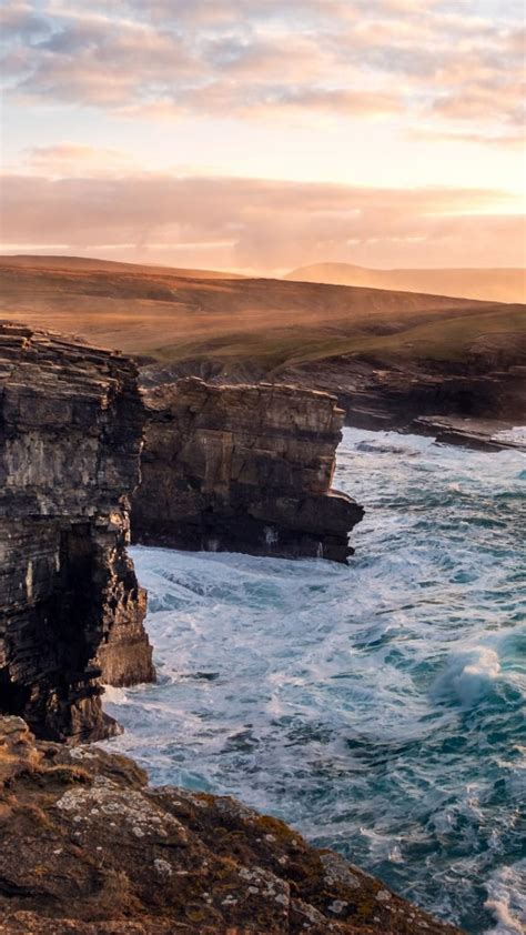 Dramatic Waves And Cliffs With Sunset Background Orkney