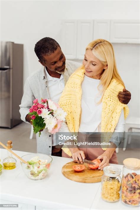 Handsome African American Husband Ting Flowers To Mature Blonde Wife