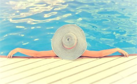 Free Photo Woman On Vacations With Hat Relaxing Swimming Pool