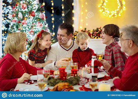 Christmas games & activities for esl kids teachers. Family With Kids Having Christmas Dinner At Tree Stock ...