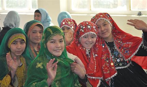 Hazara Girls Wearing Red Traditional Hijabs Sitting Next To Tajik And