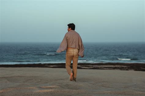 Man Walking On The Beach Towards Shore Image Free Stock Photo