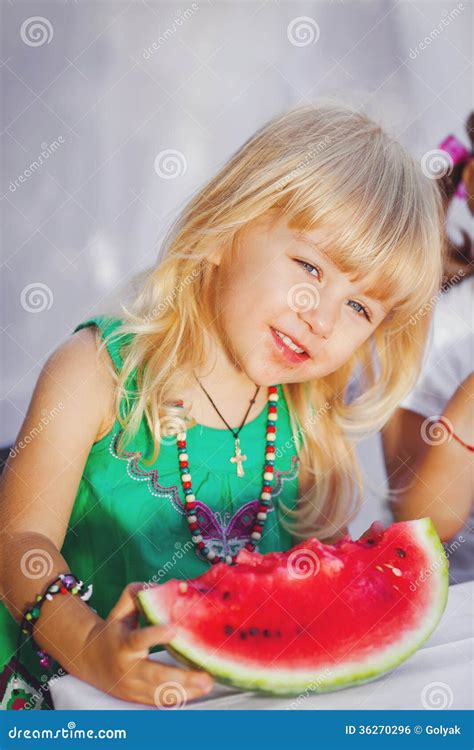 Cute Little Girl Playing With Watermelons In Summer Park Outdoors Stock