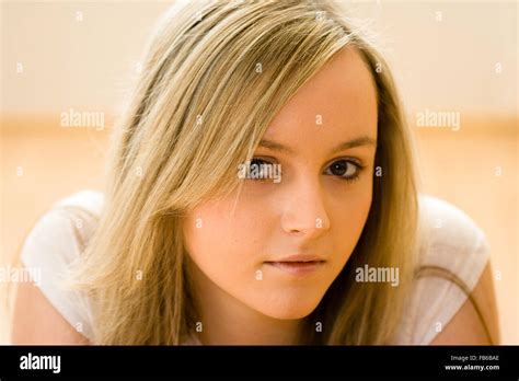head and shoulder shot of teenage 16 18 years old woman facing with eye contact long blonde