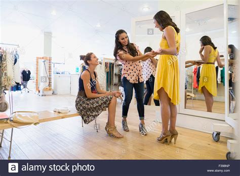 Woman Trying On Dress In Clothing Shop Stock Photo Alamy