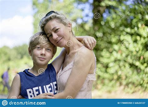 Loving Mother And Son Embracing Each Other Happily Smiling On A Summer