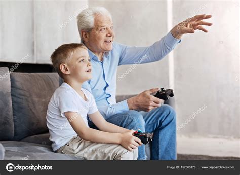 Cool Man And His Grandson Talking About Gaming Stock Photo By